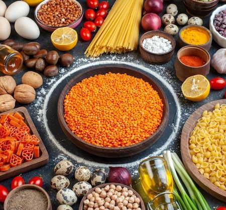front-view-orange-lentils-with-nuts-eggs-vegetables-raw-pasta-seasonings-dark-gray-background-raw-meal-diet-kitchen-color-photo-nut-bean_140725-160627