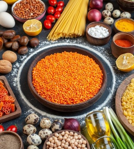 front-view-orange-lentils-with-nuts-eggs-vegetables-raw-pasta-seasonings-dark-gray-background-raw-meal-diet-kitchen-color-photo-nut-bean_140725-160627